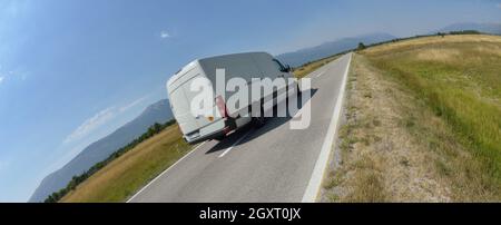 delivery cargo van for small business transportation driving fast on road Stock Photo