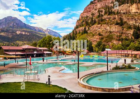 Peaceful hot springs in small town surrounded by large mountains Stock Photo