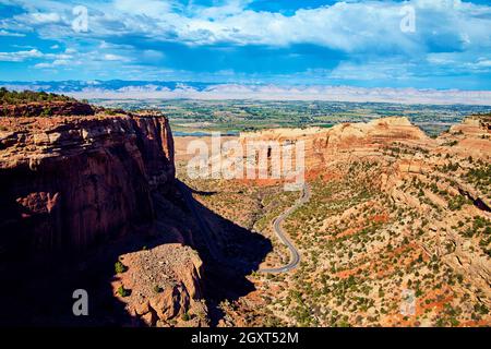 Road winding through and around large rock canyon of red rock and sand Stock Photo