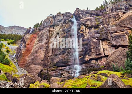 Large waterfall over vertical cliffs in mountains Stock Photo