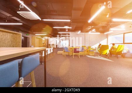 young software developers enjoying break in relaxation area of Modern sunny bright Open Plan Office Stock Photo