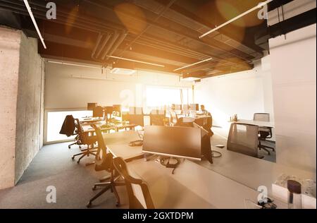 software developers working everyday job writing programming code at modern sunny bright open plan office Stock Photo
