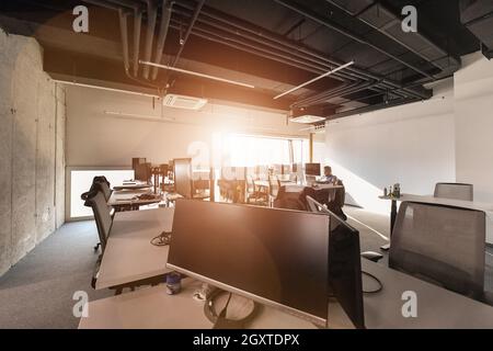software developers working everyday job writing programming code at modern sunny bright open plan office Stock Photo