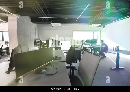 software developers working everyday job writing programming code at modern sunny bright open plan office Stock Photo