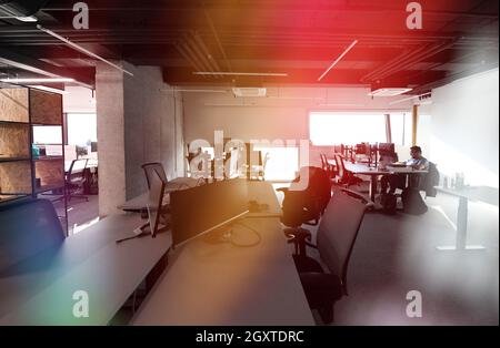 software developers working everyday job writing programming code at modern sunny bright open plan office Stock Photo
