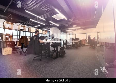 software developers working everyday job writing programming code at modern sunny bright open plan office Stock Photo