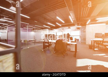 software developers working everyday job writing programming code at modern sunny bright open plan office Stock Photo