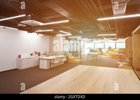 young software developers enjoying break in relaxation area of Modern sunny bright Open Plan Office Stock Photo