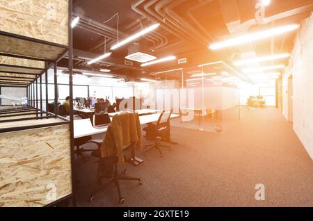 software developers working everyday job writing programming code at modern sunny bright open plan office Stock Photo