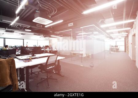 software developers working everyday job writing programming code at modern sunny bright open plan office Stock Photo