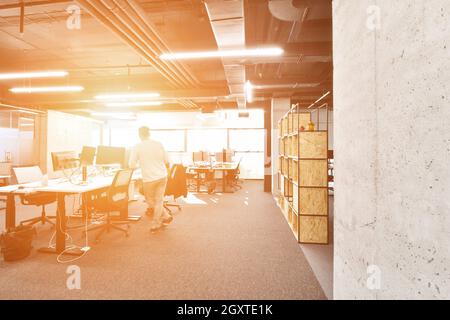 software developers working everyday job writing programming code at modern sunny bright open plan office Stock Photo