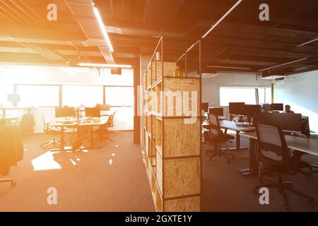 software developers working everyday job writing programming code at modern sunny bright open plan office Stock Photo