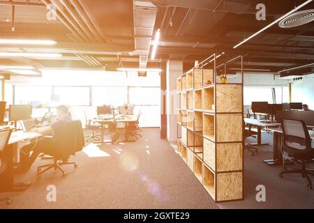 software developers working everyday job writing programming code at modern sunny bright open plan office Stock Photo