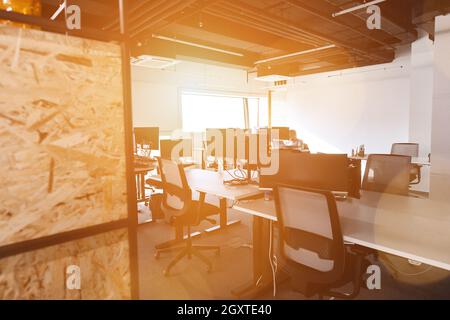 software developers working everyday job writing programming code at modern sunny bright open plan office Stock Photo