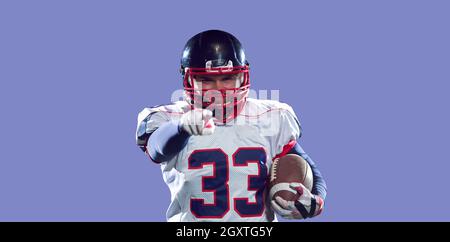 portrait of confident American football player holding ball Stock Photo