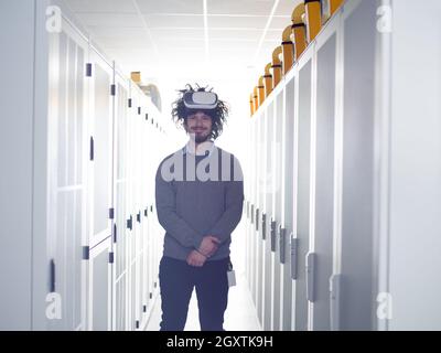 young IT engeneer using virtual reality headset over server room background Stock Photo