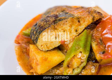 Close up view of Malay style spicy vegetarian assam fish head. Stock Photo