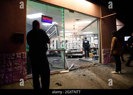 October 5, 2021: A car slammed into the Stainless Studios - Custom Tattoo Parlor in Dallas TX after being struck by another car, destroying a customer sitting area and tattoo station.None of the shop's employees or the occupants of the car were injured. The shop manager said that if a customer had not cancelled her appointment for this evening, they would have been sitting in that station when the vehicle struck.The other car fled the scene, minus a bumper, and is being sought by the Dallas Police Department. (Credit Image: © Avi Adelman/ZUMA Press Wire) Stock Photo