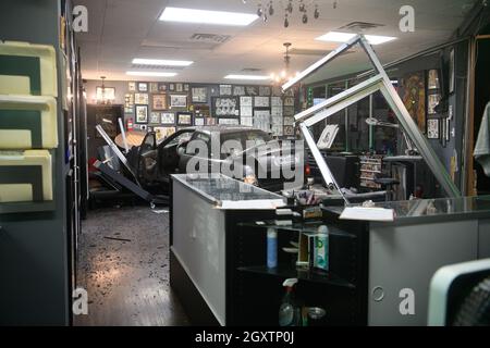 October 5, 2021: A car slammed into the Stainless Studios - Custom Tattoo Parlor in Dallas TX after being struck by another car, destroying a customer sitting area and tattoo station.None of the shop's employees or the occupants of the car were injured. The shop manager said that if a customer had not cancelled her appointment for this evening, they would have been sitting in that station when the vehicle struck.The other car fled the scene, minus a bumper, and is being sought by the Dallas Police Department. (Credit Image: © Avi Adelman/ZUMA Press Wire) Stock Photo