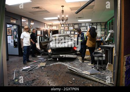 October 5, 2021: A car slammed into the Stainless Studios - Custom Tattoo Parlor in Dallas TX after being struck by another car, destroying a customer sitting area and tattoo station.None of the shop's employees or the occupants of the car were injured. The shop manager said that if a customer had not cancelled her appointment for this evening, they would have been sitting in that station when the vehicle struck.The other car fled the scene, minus a bumper, and is being sought by the Dallas Police Department. (Credit Image: © Avi Adelman/ZUMA Press Wire) Stock Photo