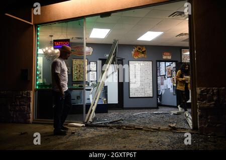 October 5, 2021: A car slammed into the Stainless Studios - Custom Tattoo Parlor in Dallas TX after being struck by another car, destroying a customer sitting area and tattoo station.None of the shop's employees or the occupants of the car were injured. The shop manager said that if a customer had not cancelled her appointment for this evening, they would have been sitting in that station when the vehicle struck.The other car fled the scene, minus a bumper, and is being sought by the Dallas Police Department. (Credit Image: © Avi Adelman/ZUMA Press Wire) Stock Photo