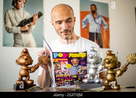 Berlin, Germany. 01st Oct, 2021. Christian Kallenberg, media entrepreneur, holds the new issue of the magazine 'Pop Rocky' in his office. The magazine was discontinued in 1998 and will be republished with a special issue on 07.10.2021. Credit: Fabian Sommer/dpa/Alamy Live News Stock Photo