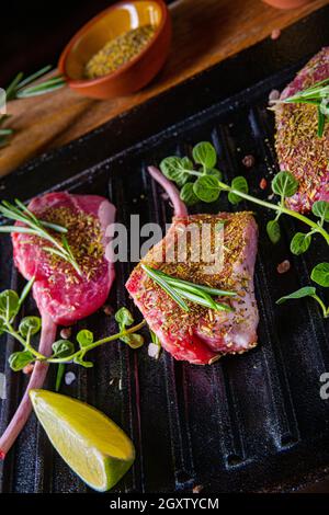 Seasoned and Herb Marinated Raw Lamb Chops Stock Photo