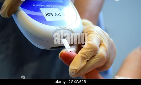 File photo dated 3/10/2014 of a nurse giving a patient a diabetes test. Almost one in 10 people in the UK will have diabetes by 2030, with obesity fuelling a rise in cases, a charity has warned. Some 5.5 million people are likely to be living with diabetes within the next decade, putting them at risk of 'devastating complications' including heart attacks, kidney failure, stroke, amputation and blindness, Diabetes UK said. Issue date: Wednesday October 6, 2021. Stock Photo