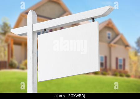 Blank Real Estate Sign in Front of Beautiful New House. Stock Photo