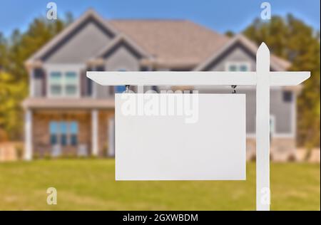 Blank Real Estate Sign in Front of Beautiful New House. Stock Photo