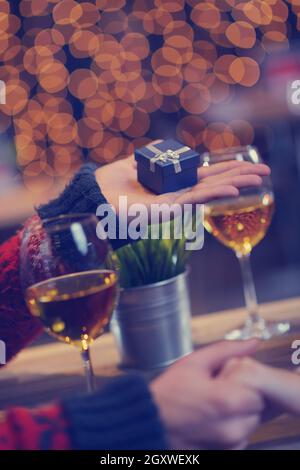 The young man gives a wedding ring   gift to  girl in restaurant Stock Photo