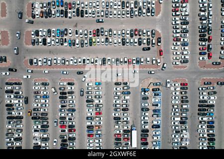 Car parking of a shopping center, top-down aerial shooting. Stock Photo