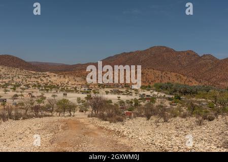 Landscape on the Kunene River with Himba village, Namibia Stock Photo