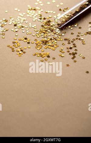 Golden sparkles stars on gold holiday background. Festive backdrop for your projects Stock Photo