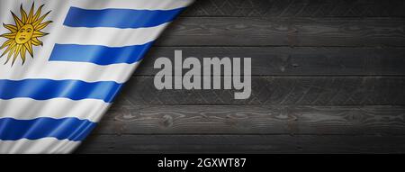 Uruguay flag on black wood wall. Horizontal panoramic banner. Stock Photo