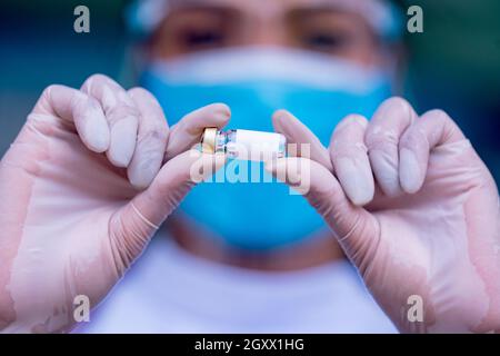 Close-up hand doctor or nurses showing proved Antiviral vaccine bottles.Doctor giving Prophylactic HPV vaccination. Stock Photo