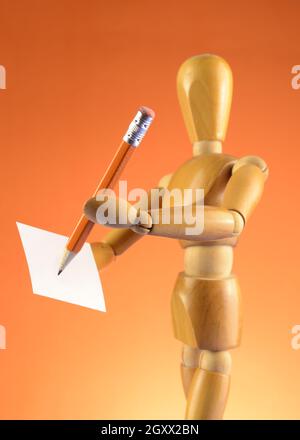 Premium Photo  Wooden mannequin holding a pencil. drawing or
