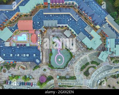 Bird's eye view of a theme park showing buildings and roads and a pond Stock Photo