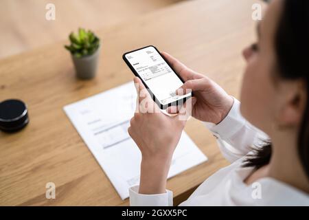 Taking Invoice Document Photo Using Phone Or Smartphone Stock Photo