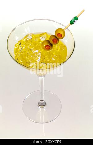 Close-up of cocktail martini with olives on table against isolated on white Stock Photo