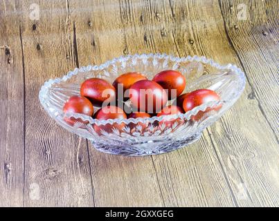 Painted Easter eggs in a crystal vase. Red painted chicken eggs for easter. Stock Photo