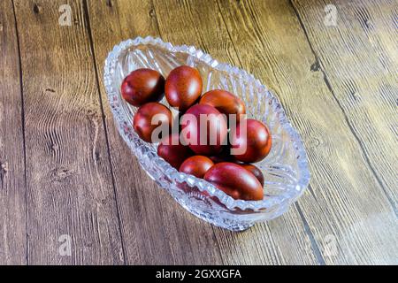 Painted Easter eggs in a crystal vase. Red painted chicken eggs for easter. Stock Photo