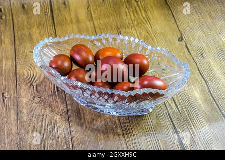 Painted Easter eggs in a crystal vase. Red painted chicken eggs for easter. Stock Photo