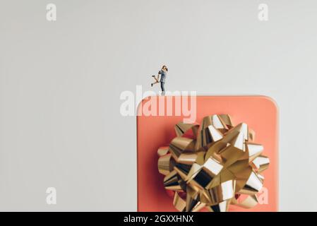 Couple hugging on a giant gift box Stock Photo