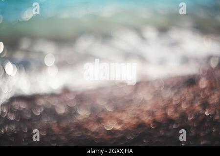 Water bokeh lights on the coastline.Natural background. Stock Photo