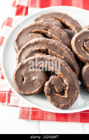 Sweet pastry palmeritas with chocolate icing on plate. Stock Photo