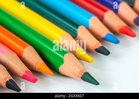 Close up picture of many  colored pencil crayons on white background. Assortment of sharpened colored pencils/ Colored drawing pencils. Selective focu Stock Photo