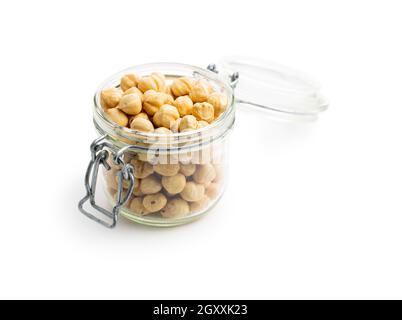 Peeled roasted hazelnut kernels in jar isolated on white background. Stock Photo