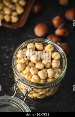 Peeled roasted hazelnut kernels in jar. Stock Photo
