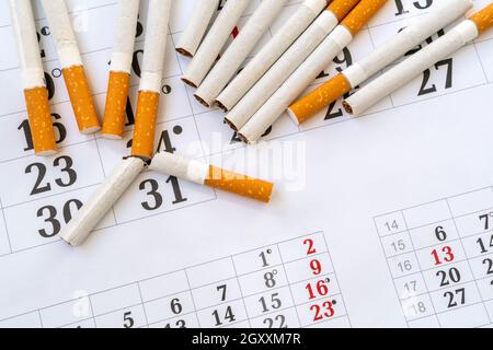 Quit smoking - today! The broken cigarette on a calendar. World No Tobacco  Day Concept Stop Smoking Stock Photo